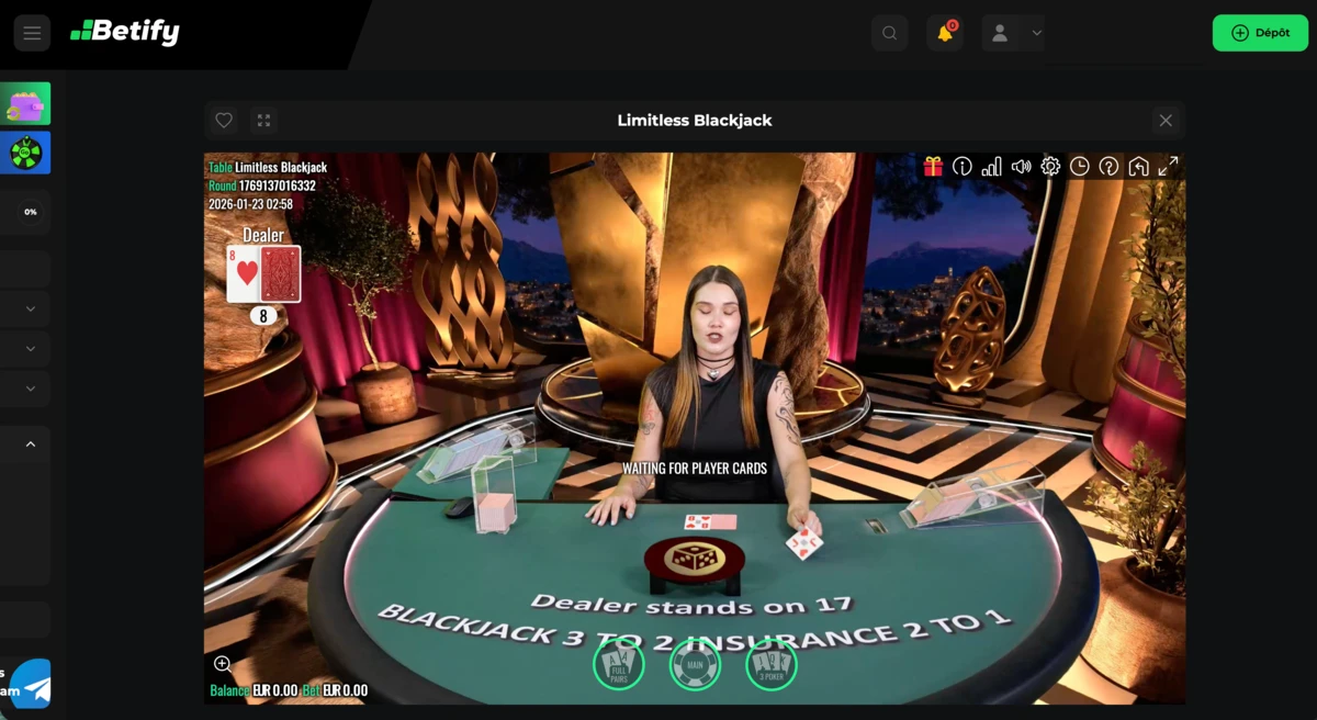 Capture d’écran du jeu Limitless Blackjack en casino en direct avec une croupière face aux joueurs, table de blackjack verte affichant les règles « dealer stands on 17 », les cartes du dealer et des joueurs, ainsi que l’interface de mises et de solde visible à l’écran, tel qu’il est proposé dans la section live casino de Betify Casino.