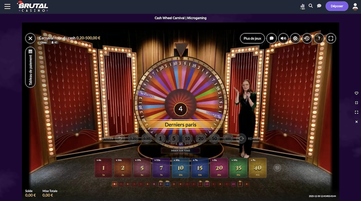Jeu de casino live Cash Wheel Carnival sur Brutal Casino avec une croupi&egrave;re en direct devant une grande roue color&eacute;e, des options de mise visibles et un compte &agrave; rebours avant le lancement.