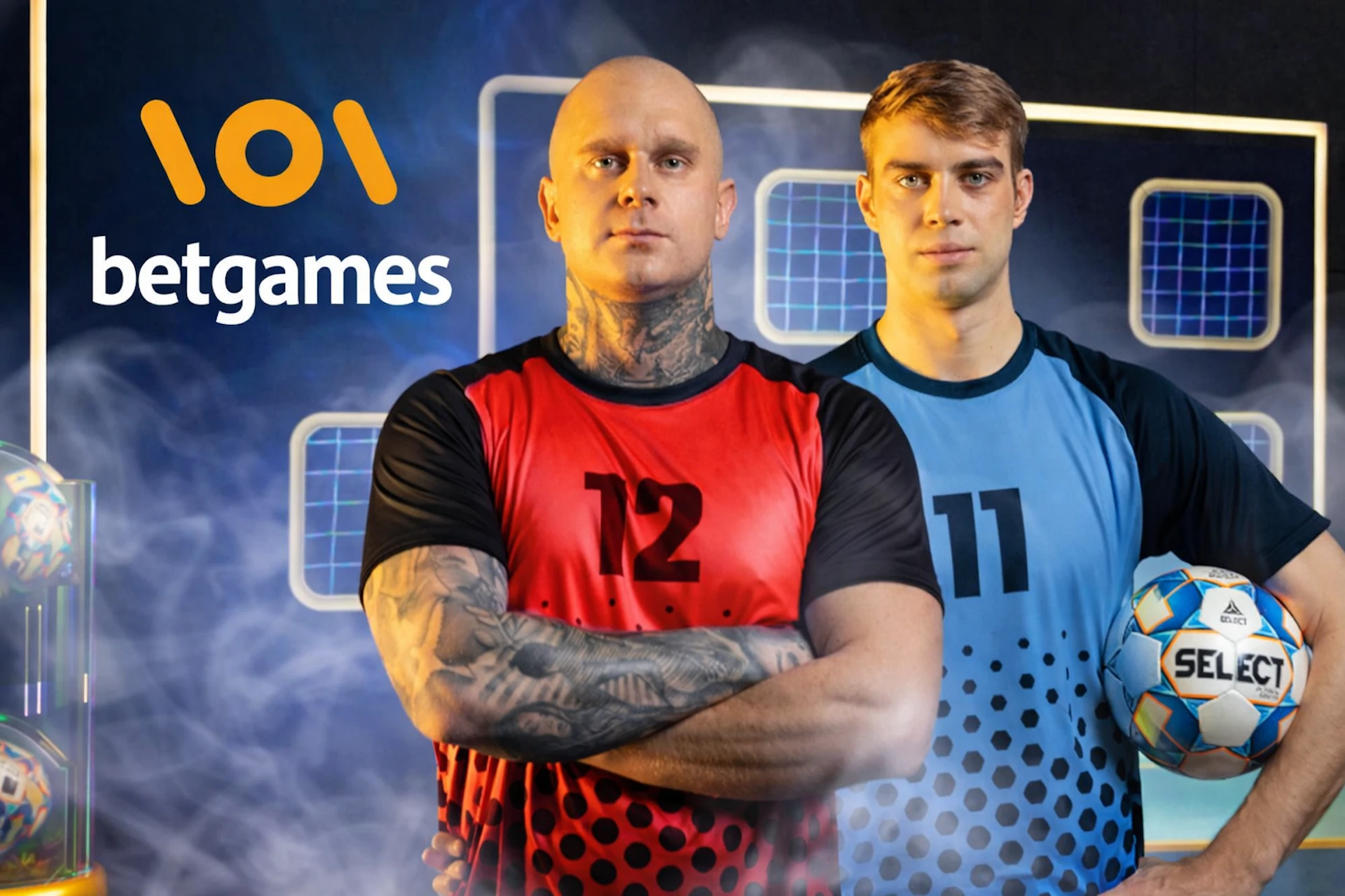 Deux joueurs sportifs en maillot rouge et bleu posent dans un d&eacute;cor high-tech avec ballons et &eacute;crans lumineux, logo BetGames visible, ambiance comp&eacute;tition et paris en ligne.